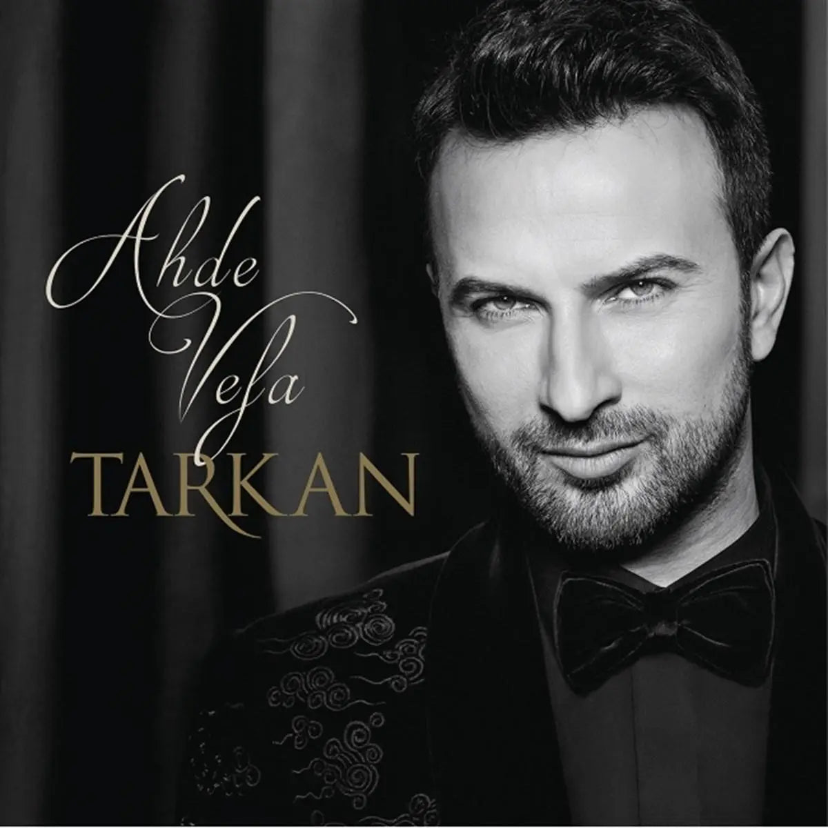 Tarkan Ahde Vefa album cover featuring a black and white portrait of the singer in a suit with elegant script text.