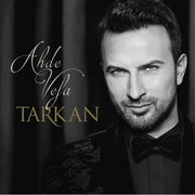 Tarkan Ahde Vefa album cover featuring a black and white portrait of the singer in a suit with elegant script text.